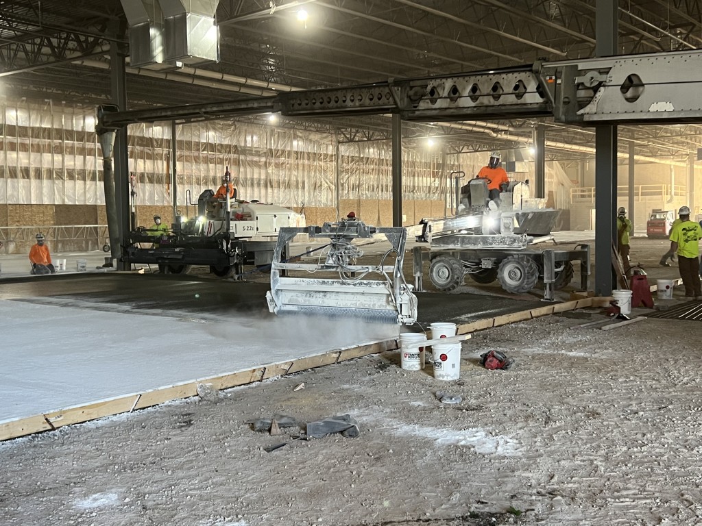9-22-22: Concrete hardener is spread on the newly leveled concrete