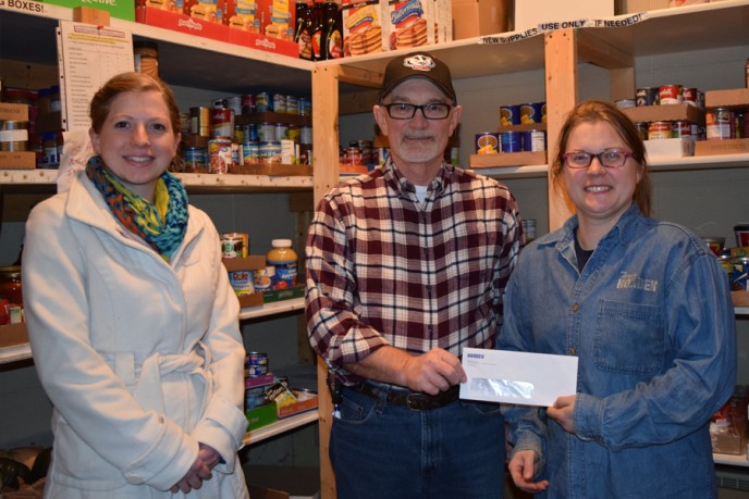 Kondex employees at food pantry donating check