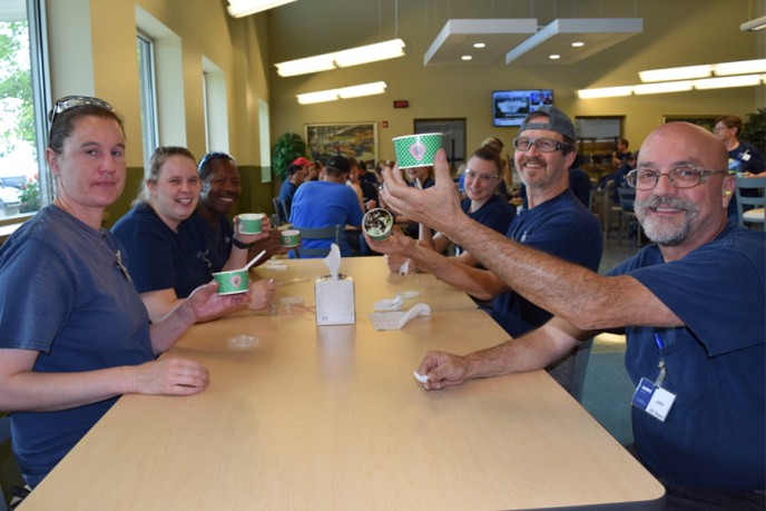 Employees at ice cream social in cafeteria