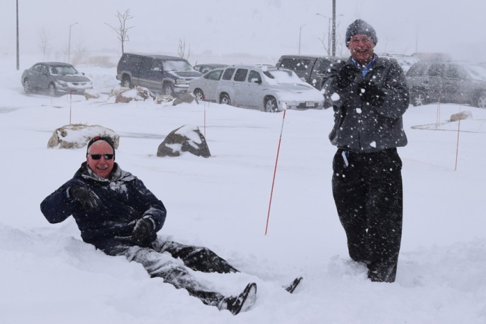 Kondex employees sitting in snowbank