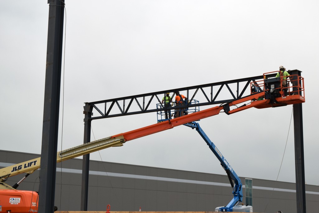 7-6-22: Ironworkers erecting the steel columns, girders, and joists to support the expansion walls and roof