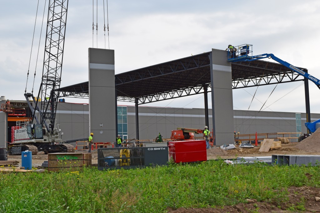 7-11-22: A crane transfers the precast panels into place