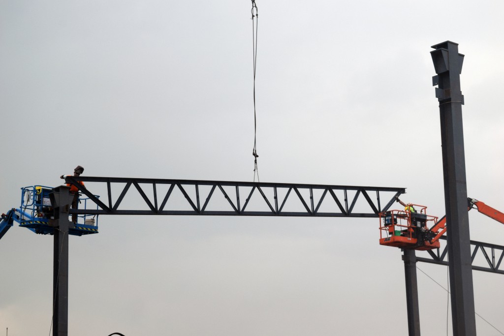 7-6-22: Ironworkers erecting the steel columns, girders, and joists to support the expansion walls and roof