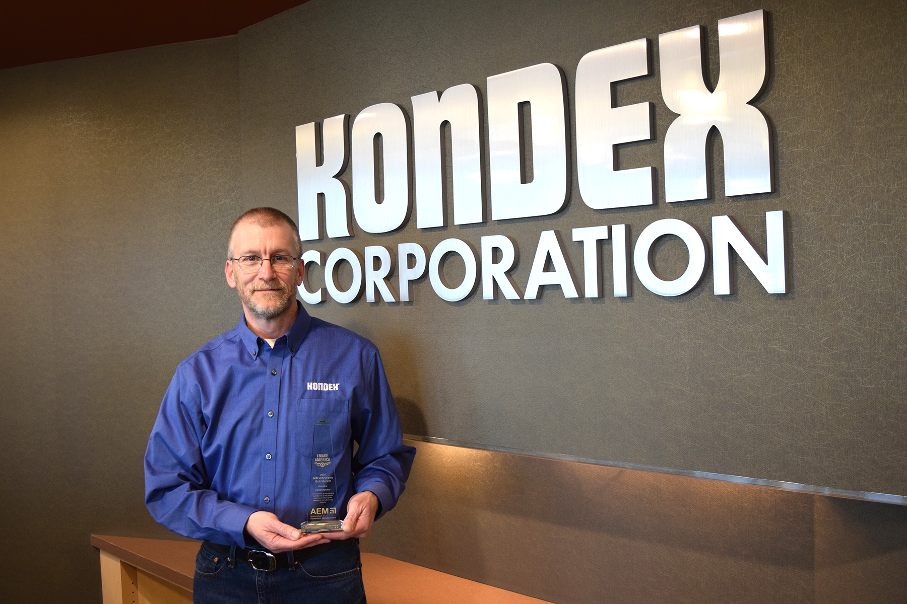 Kondex President Keith Johnson holding 2020 AEM Advocacy Gold Award