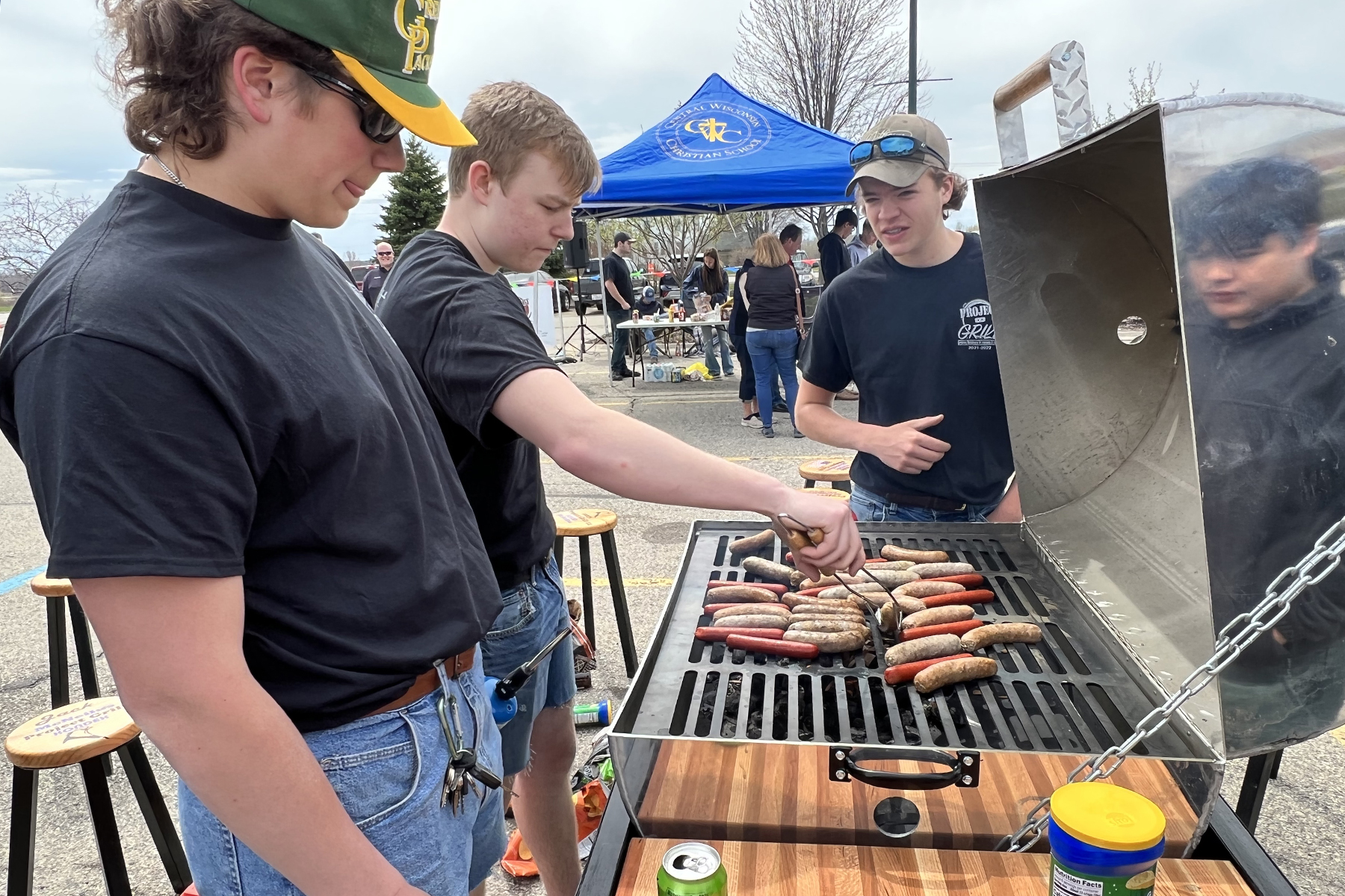 Students grilling brats and burgers at the Project GRILL unveiling event