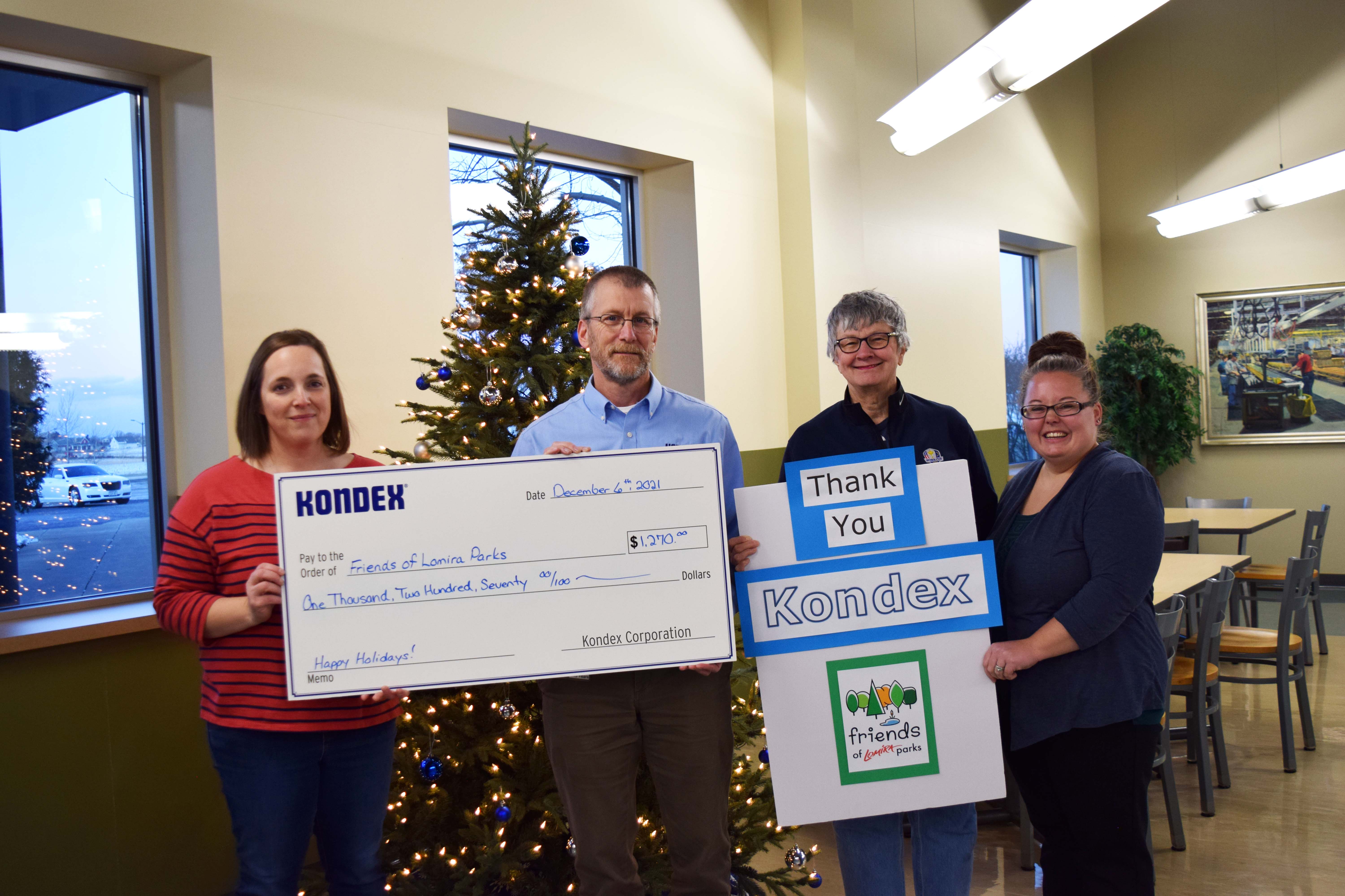 Kondex President Keith Johnson holding a check with members of the Friends of Lomira Parks