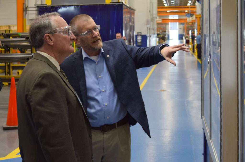 Kondex President Keith Johnson explaining production metrics to Dr. Walz