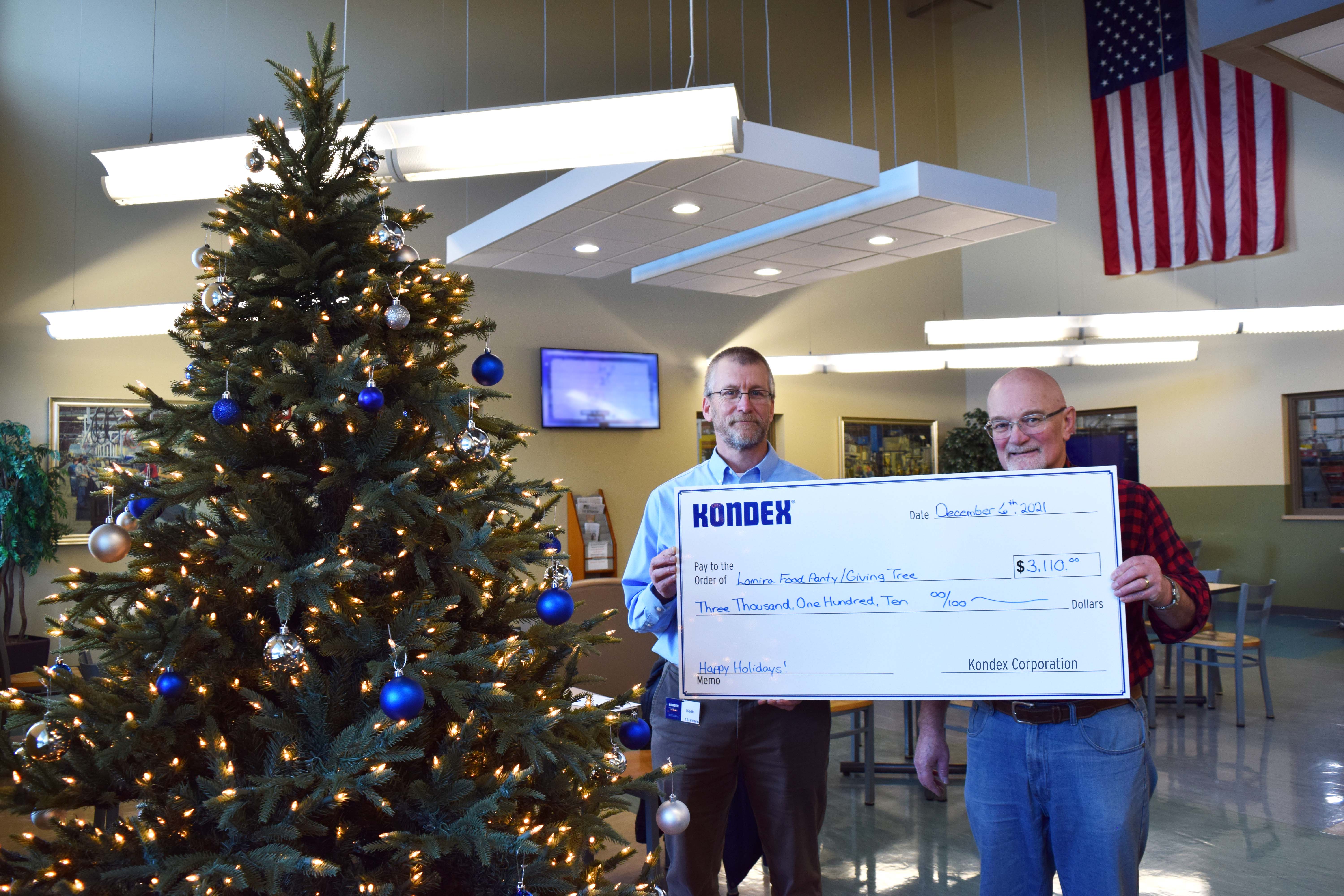 Kondex President Keith Johnson holding a check with Lomira Compassionate Fund Chairman Ralph Germain